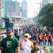 people exercise jogging , walking ,cycling along sudirman road at car free day on sunday morning in jakarta city, indonesia