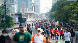 people exercise jogging , walking ,cycling along sudirman road at car free day on sunday morning in jakarta city, indonesia